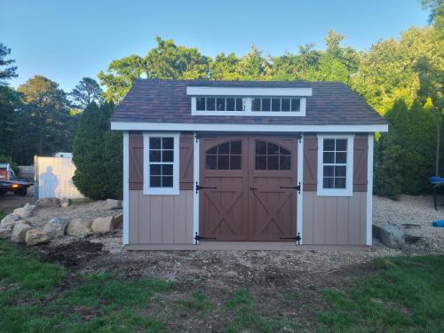 LISB-Medford-12x14-garden-transom-carriage-doors-z-shutters.-Taupe-with-chestnut-doors-and-shutters-brownwood-roof-5